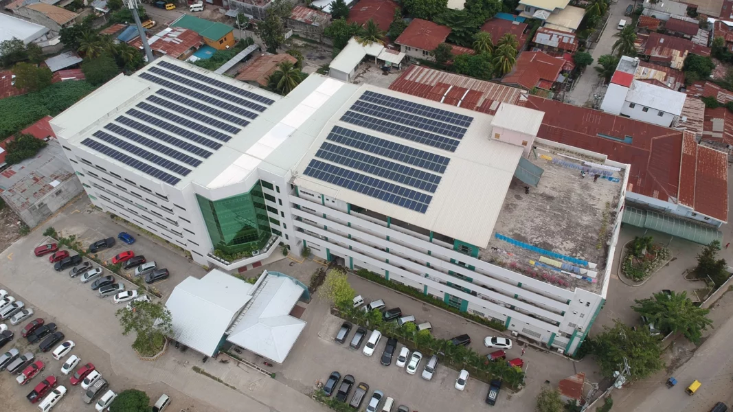 A large array of solar panels installed on the roof or exterior framework of the Madonna and Child Hospital building in Barangay Carmen, Cagayan de Oro City.