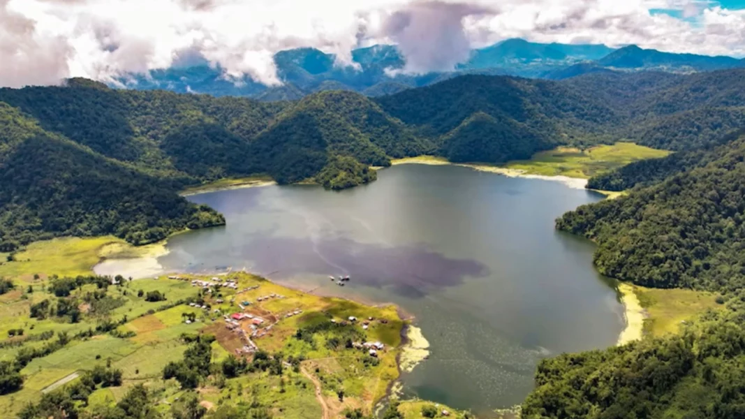 A scenic panoramic view of the lush, forested mountain ridges and peaks of Mt. Inayawan Range Natural Parks under a clear sky in Northern Mindanao.