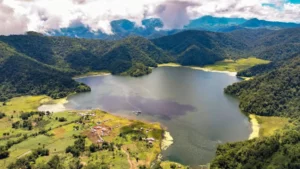 A scenic panoramic view of the lush, forested mountain ridges and peaks of Mt. Inayawan Range Natural Parks under a clear sky in Northern Mindanao.