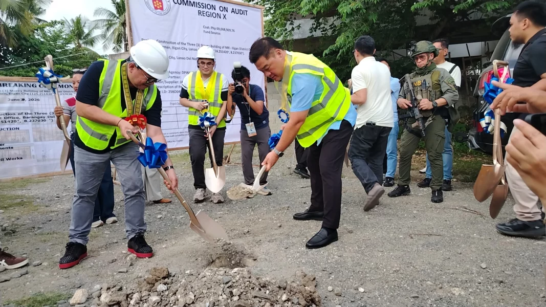 National Bureau of Investigation Director Melvin Matibag, Iligan District Chief Medrobel Ylanan, and Mayor Frederick Siao hold shovels at a construction site dirt mound during a groundbreaking ceremony.
