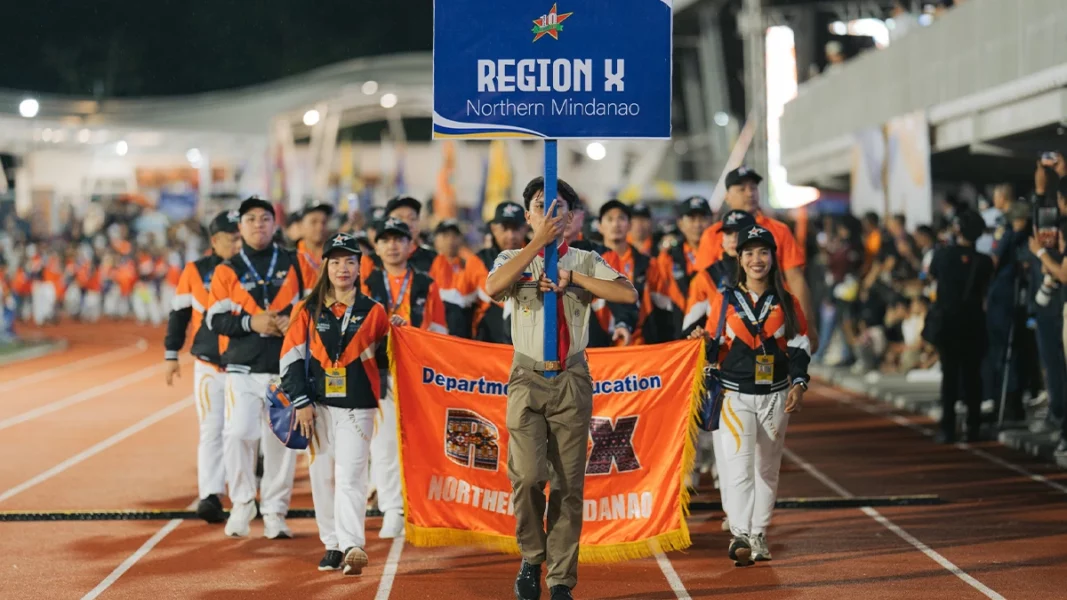 The Region 10 Mas Asenso NorMin Stars delegation marching on the stadium track and field during the opening parade of the 2026 Palarong Pambansa in Agusan del Sur.