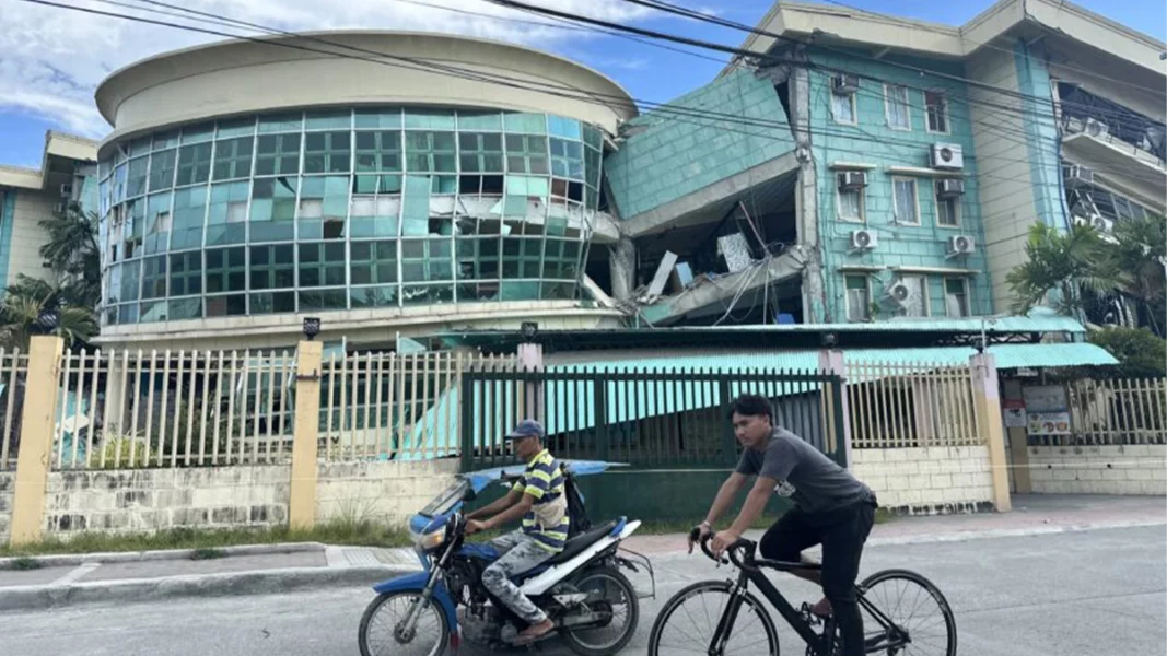 Visible cracks and structural damage on a concrete school building at the Notre Dame of Dadiangas University Integrated Basic Education Department campus in General Santos City following a magnitude 7.8 earthquake.