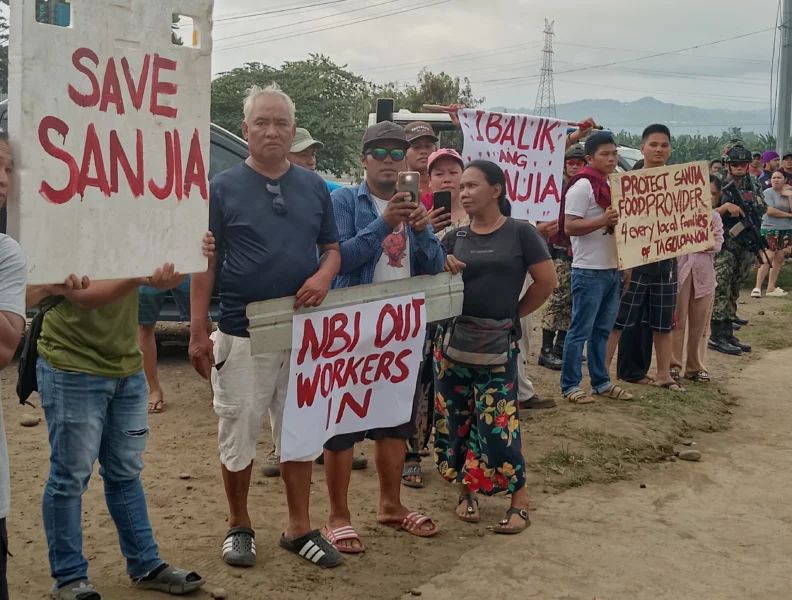 Sanjia steel plant workers holding protest placards after a National Bureau of Investigation (NBI) raid and closure in Barangay Baluarte, Tagoloan, Misamis Oriental.