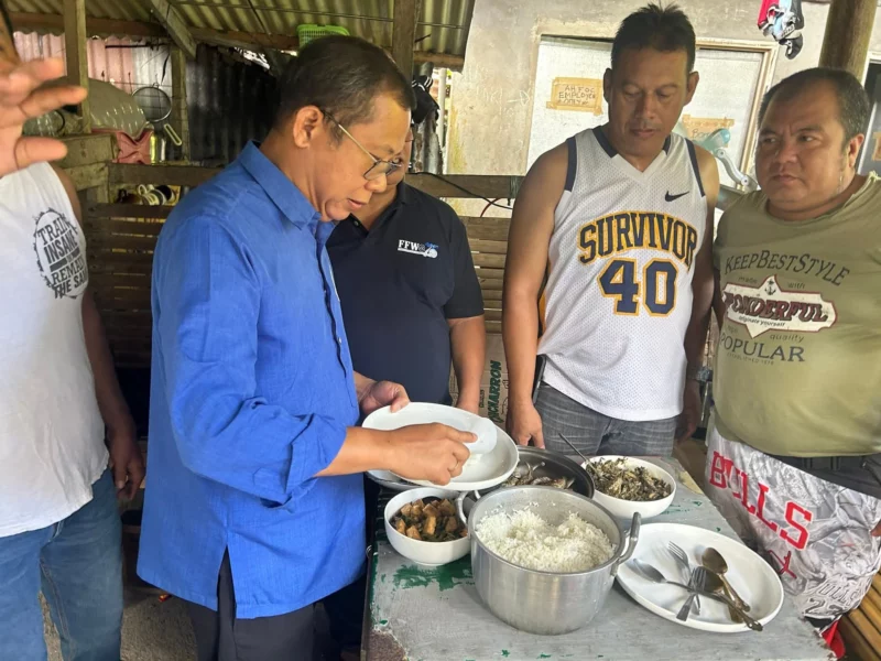 Federation of Free Workers President Sonny Matula eating lunch with striking transport workers on a picket line in Infanta, Quezon.