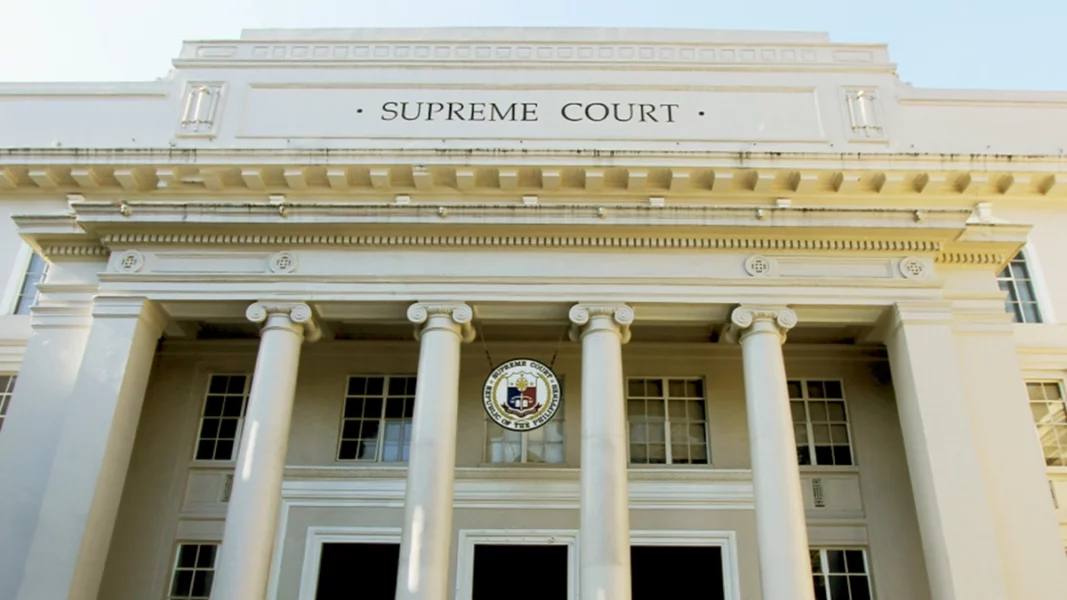 The neoclassical facade and official seal of the Supreme Court of the Philippines building along Padre Faura Street in Manila.