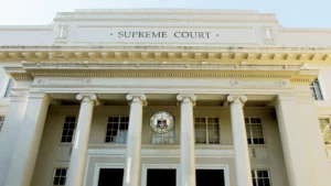 The neoclassical facade and official seal of the Supreme Court of the Philippines building along Padre Faura Street in Manila.