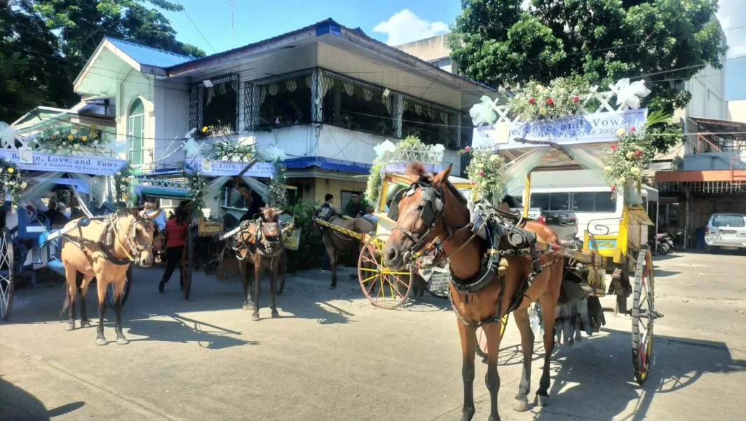 Flower-adorned tartanillas carrying newlywed couples during the Kasalan ng Bayan mass wedding in Iligan City.