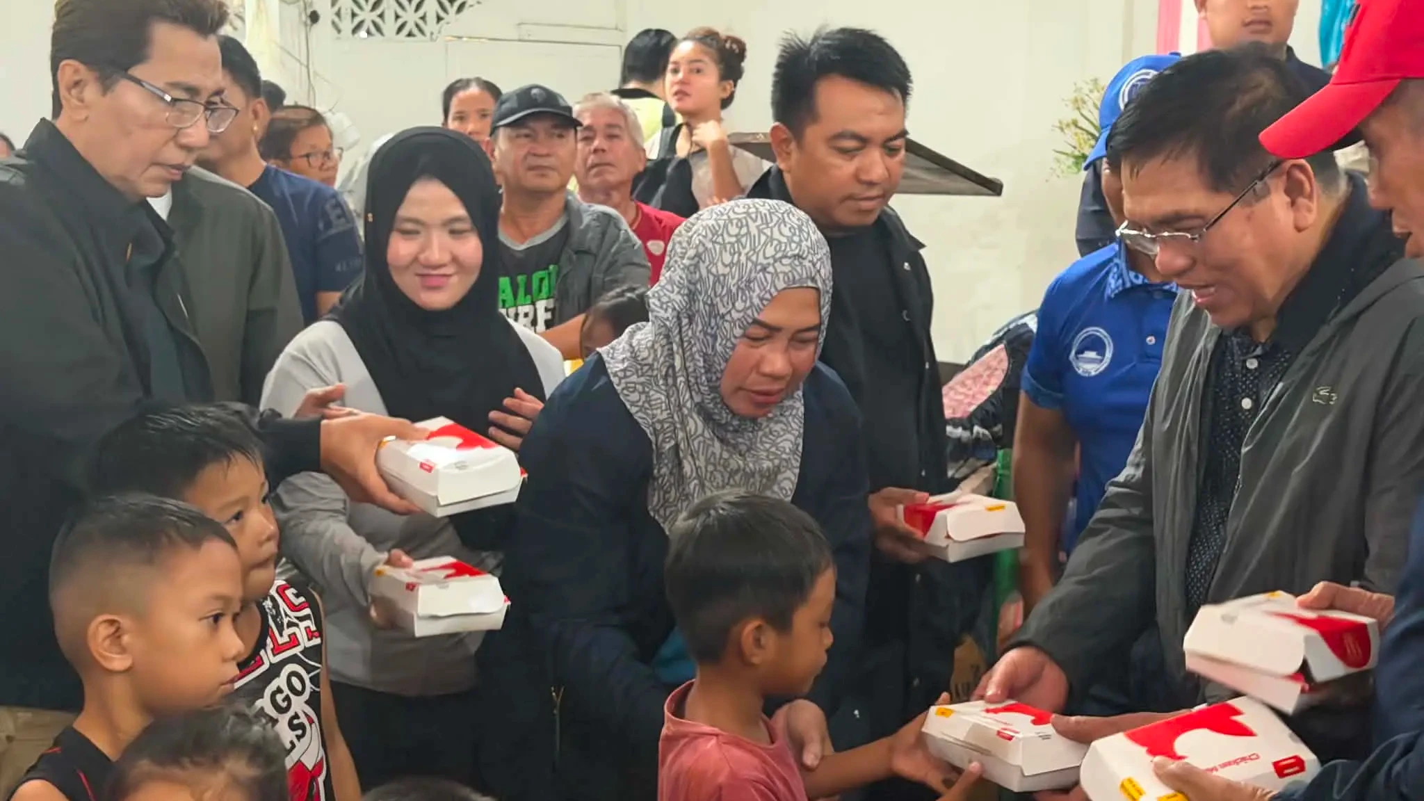 Helping Flood Victims. BARMM Chief Minister Abdulraof Macacua distributes food packs and other relief assistance under the SAM-KITS Program to families affected by flooding in Parang, Maguindanao del Norte, on Friday. More than 44,000 families across the region have been affected by widespread flooding. (Photo courtesy of the Office of the Chief Minister, BARMM)