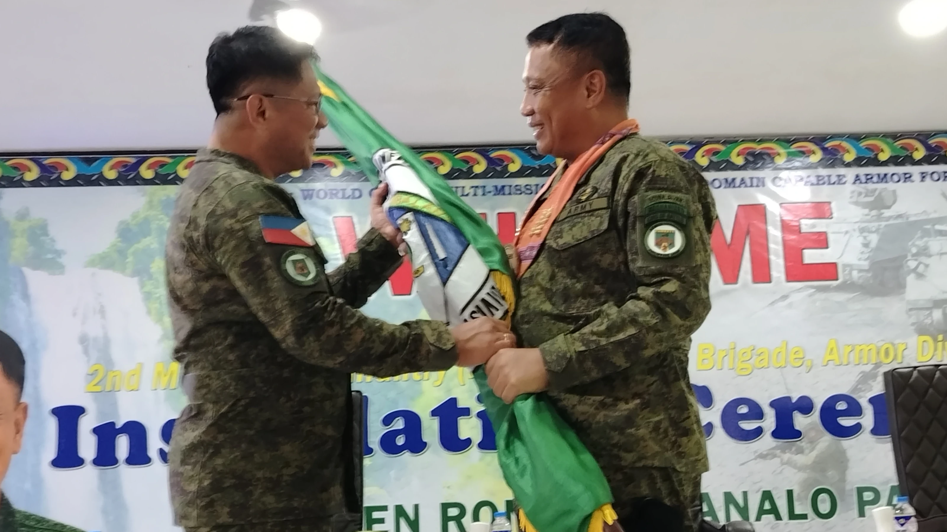 ASSUMING COMMAND. Brig. Gen. Bernardo A. Taqueban receives the brigade colours during his installation as commander of the 2nd Mechanized Infantry "Magbalantay" Brigade at Camp Sultan Badrodin in Iligan City. Armor Division Commander Maj. Gen. Ronel R. Manalo said military leaders are responsible for safeguarding the brigade's mission, readiness, discipline and the welfare of its personnel. (Photo by Bonita L. Ermac)