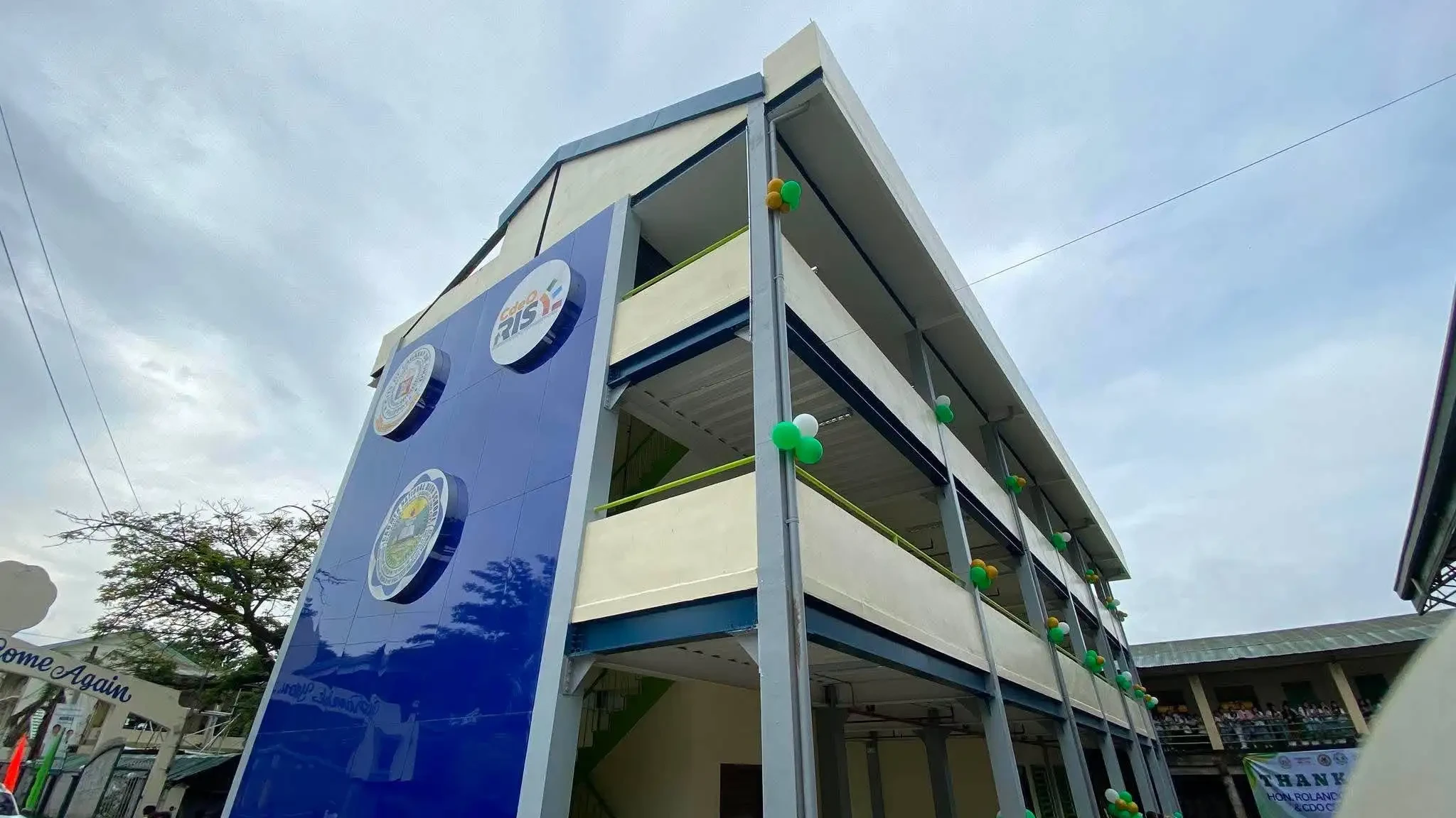 A new three-story, nine-classroom Smart School Building stands decorated with balloons during its formal turnover ceremony at Carmen National High School in Barangay Carmen, Cagayan de Oro City, on Friday, July 31, 2026. The Cagayan de Oro City government, in partnership with local education officials, turned over the fully furnished facility to address classroom congestion and provide technology-assisted learning spaces. (Photo courtesy of Cagayan de Oro City Information Office)