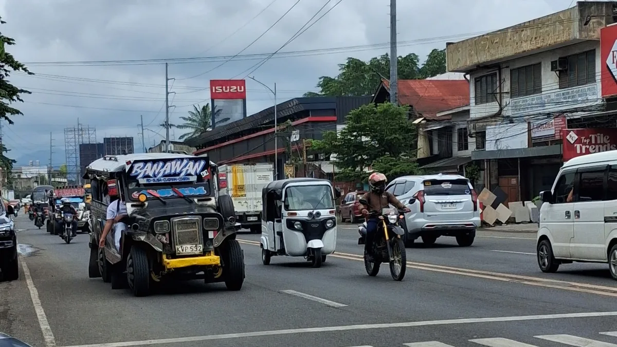 DRIVERS UNDER PRESSURE. Public utility jeepneys, taxis, motorcycles and other vehicles ply a major highway in Cagayan de Oro City on Tuesday as a fresh round of fuel price hikes takes effect, with diesel rising by ₱10.68 per liter, gasoline by ₱3.65, and kerosene by ₱11.77, adding pressure on public transport drivers and motorists already grappling with higher operating costs. (Photo by Ben Balce)