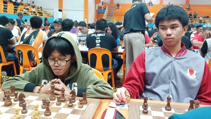 Arena International Master Miykael Jerahmiel Lapad of Laguindingan, left, matches wits with National Master Keith Adriane Ilar of Maramag, Bukidnon, during the Gov. Henry S. Oaminal Open Chess Championships 2026 in Ozamiz City, Monday, July 13, 2026. The high-profile tournament gathered elite chess prodigies and master-rated players from across Northern Mindanao. (Photo by Lynde Salgados)
