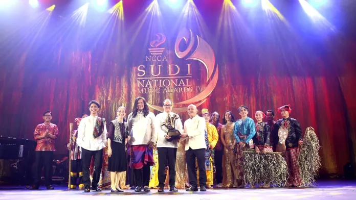 Representatives and performers of the Mindanao State University–Iligan Institute of Technology’s Integrated Performing Arts Guild (MSU-IIT IPAG) accept the NCCA SUDI National Music Award trophy during a conferment ceremony at the Metropolitan Theater in Manila. Photo Courtesy of National Commission for Culture and the Arts.