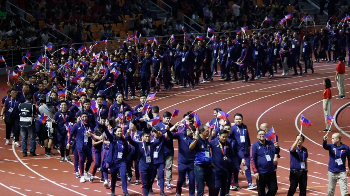 Members of Team Philippines wave national flags as they parade along the athletics track during the closing ceremony of the 30th Southeast Asian Games in New Clark City, Capas, Tarlac. Following full financial clearance of its ₱2.08 billion budget, the Philippine Southeast Asian Games Organizing Committee urged the public to remember the country's historic overall championship performance alongside the financial accounting. Photo courtesy of Wikipediacommons