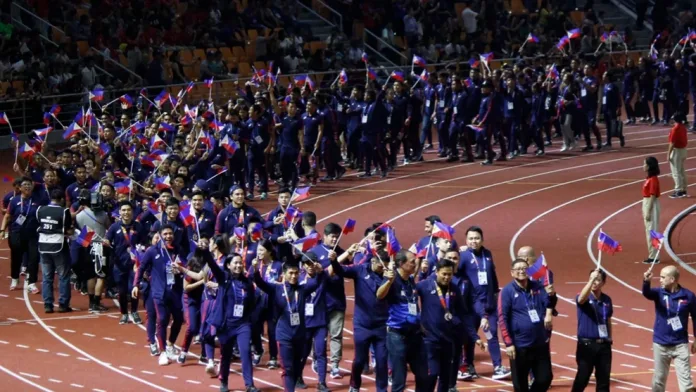 Members of Team Philippines wave national flags as they parade along the athletics track during the closing ceremony of the 30th Southeast Asian Games in New Clark City, Capas, Tarlac. Following full financial clearance of its ₱2.08 billion budget, the Philippine Southeast Asian Games Organizing Committee urged the public to remember the country's historic overall championship performance alongside the financial accounting. Photo courtesy of Wikipediacommons