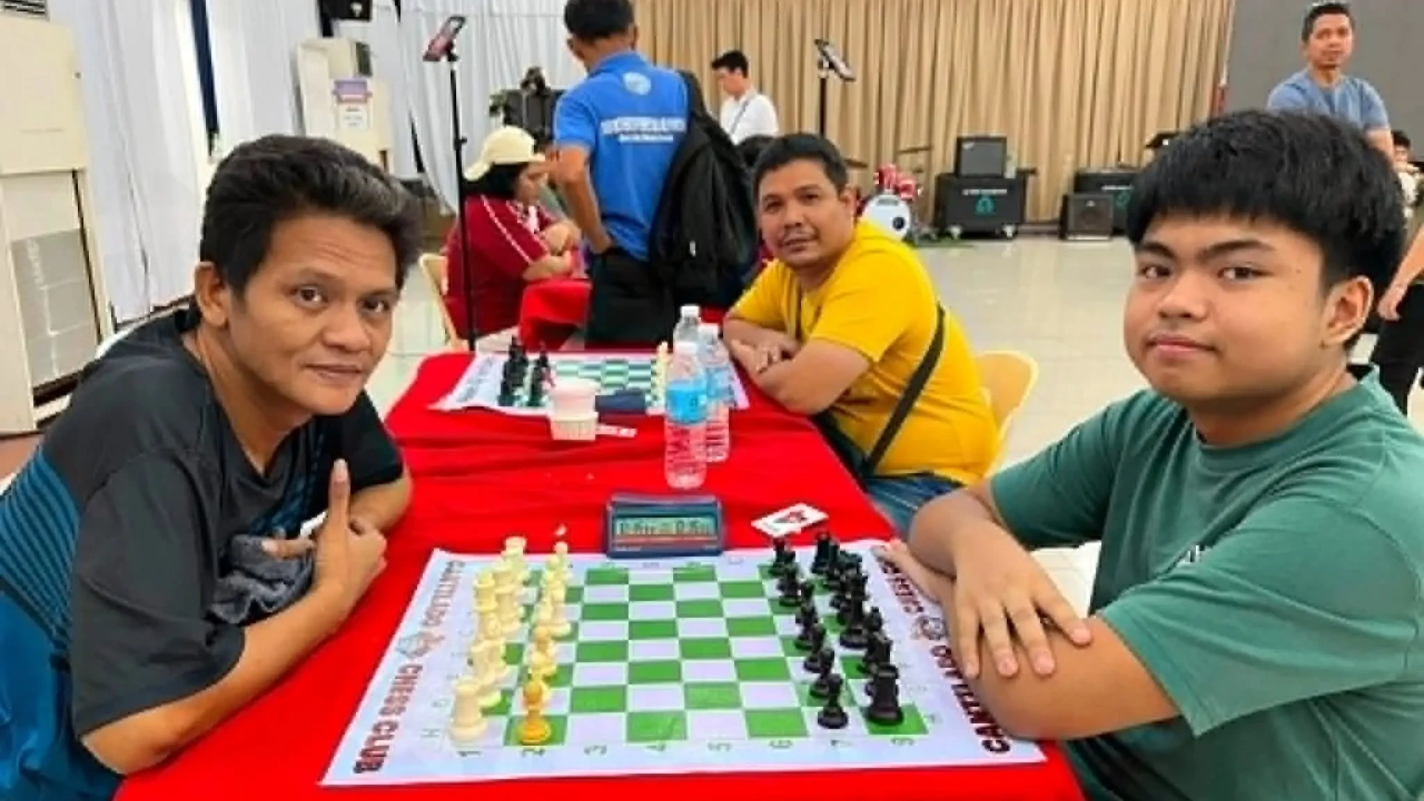 Chess player Sebastian Marbas sits at a chessboard across from his mentor Nazario Ubanan during the final round of the Cagayan de Oro City Post-Clinic Chess Tournament at the City Tourism Hall.