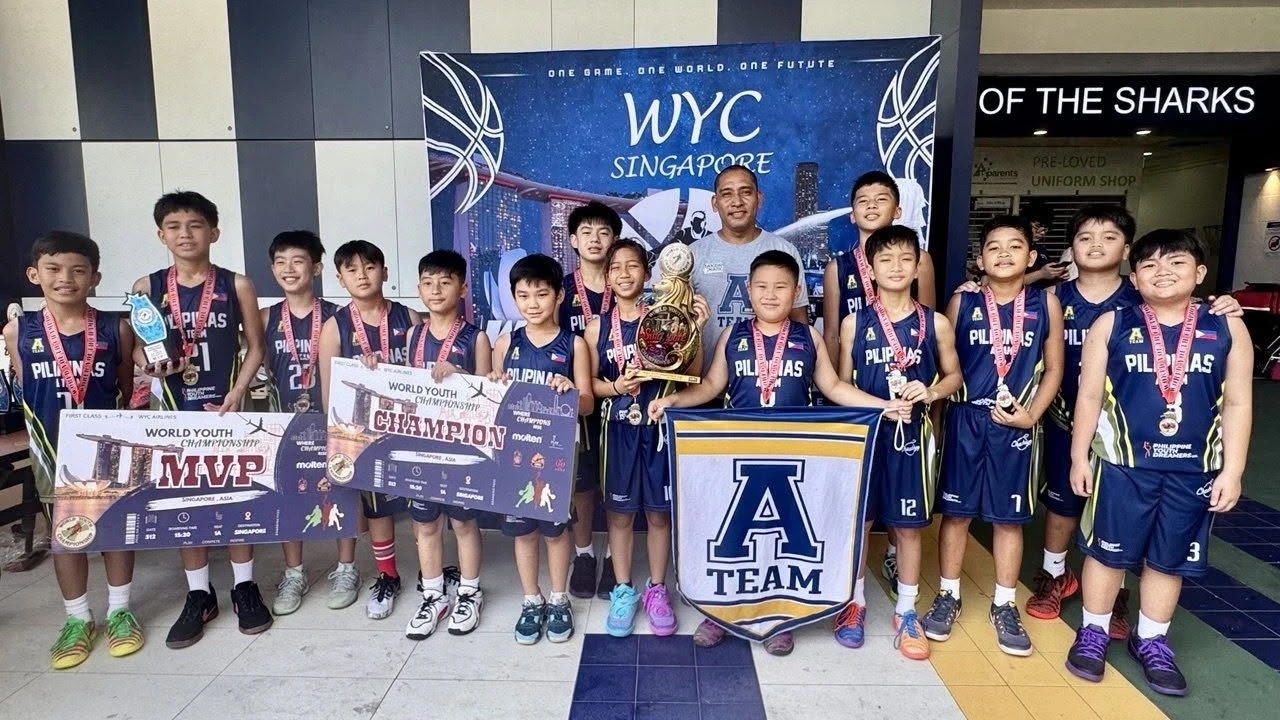 WORLD YOUTH CHAMPIONS: Cagayan de Oro’s A-Team Pilipinas and head coach Arvin Martinez pose with their trophy after winning the U11 World Youth Championship finals in Singapore on Aug. 9, 2026. Tournament MVP Rafael “Peja” Cabusca Reyes (left, holding board) led the squad to its first international title. (Photo courtesy of Philippine Youth Dreamers Organization)