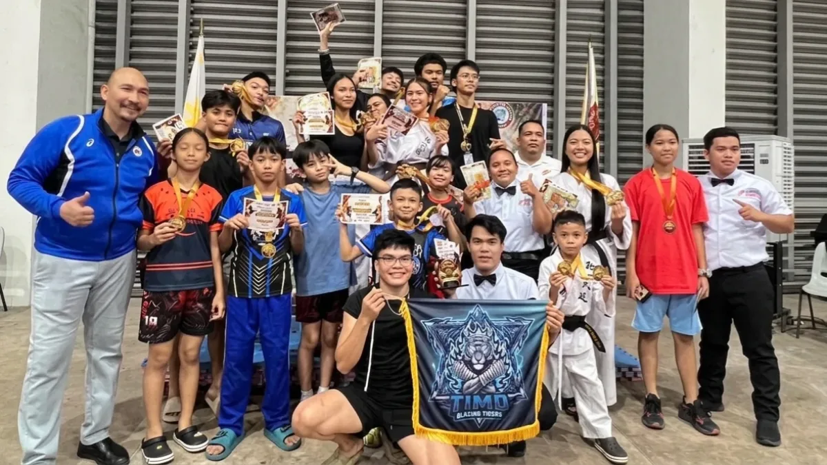 KADAYAWAN KICKBOXING CHAMPIONS: Members, coaches, and officials of the Tong-Il Moo-Do Blazing Tigers from Davao del Norte pose with their medals, certificates, and banner after being crowned overall champions at the 2026 Kadayawan Mindanao Invitational Kickboxing Tournament at LPU Davao on Saturday, Aug. 15, 2026. (Photo courtesy of Tong-Il Moo-Do Blazing Tigers)