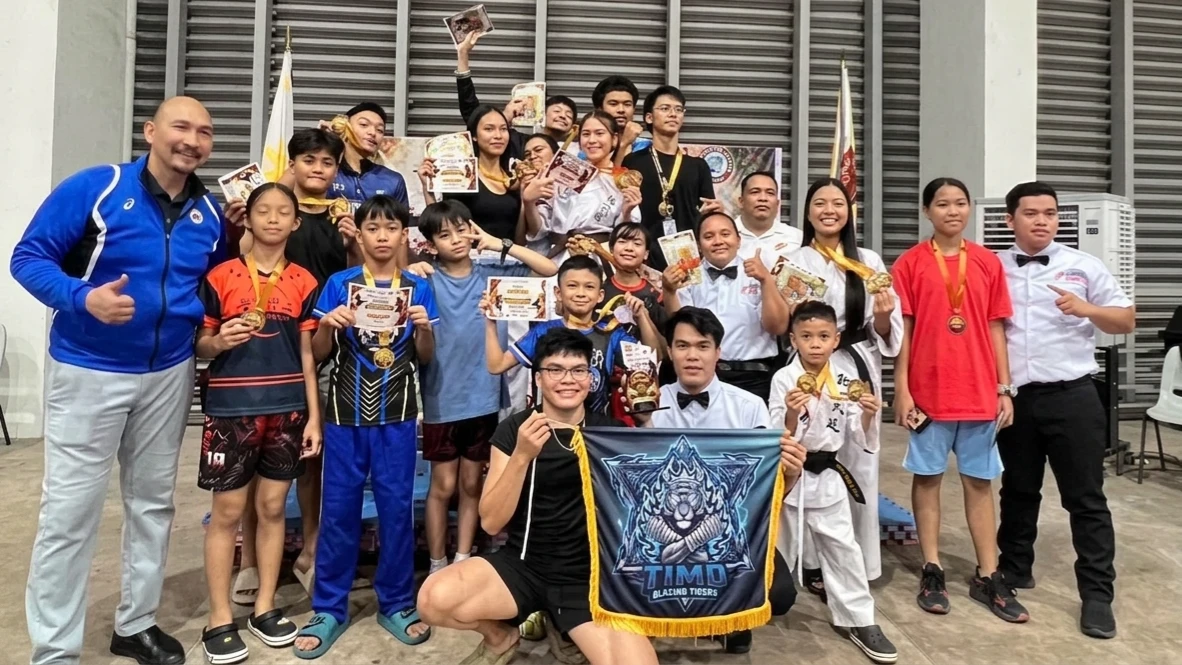 KADAYAWAN KICKBOXING CHAMPIONS: Members, coaches, and officials of the Tong-Il Moo-Do Blazing Tigers from Davao del Norte pose with their medals, certificates, and banner after being crowned overall champions at the 2026 Kadayawan Mindanao Invitational Kickboxing Tournament at LPU Davao on Saturday, Aug. 15, 2026. (Photo courtesy of Tong-Il Moo-Do Blazing Tigers)