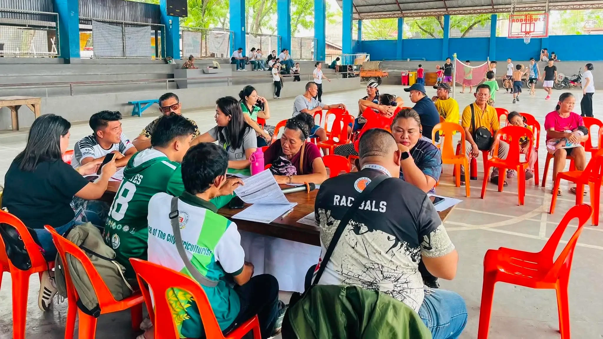 Staff members from the Office of the City Agriculturist process forms for local farmers during a mobile registration caravan at a covered court in Barangay Bugo, Cagayan de Oro City, on Friday, July 31, 2026. Twenty-nine local growers updated and verified their official records under the national registry for agricultural workers during the event. (Photo courtesy of Office of the City Agriculturist)