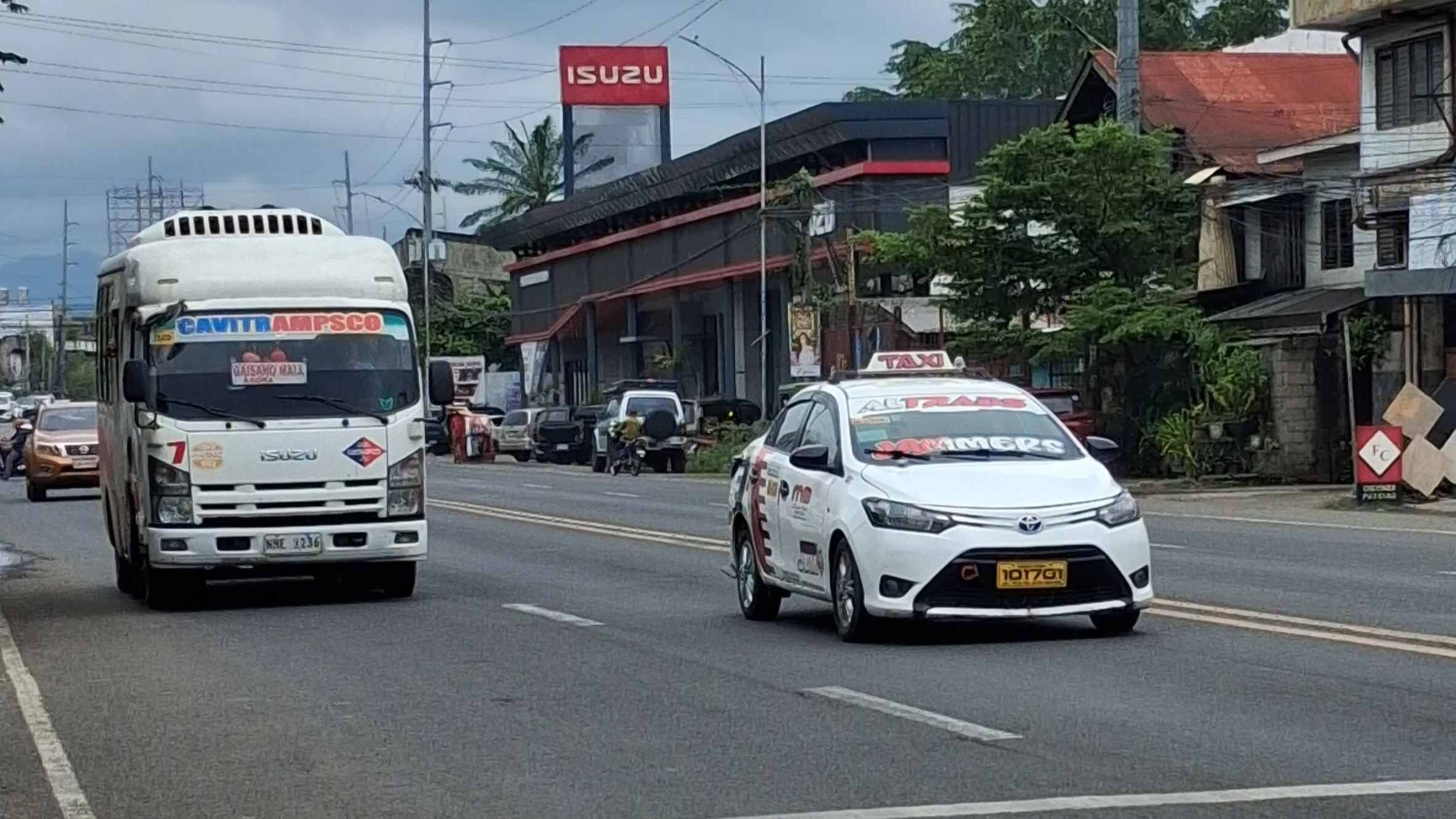 A provincial bus travels along the national highway in Cagayan de Oro City, as local authorities initiate a month-long dry run of the city's revised traffic scheme. The pilot implementation tests a long-delayed traffic ordinance designed to manage public utility vehicle flow along major thoroughfares. (Photo by Ben Balce)