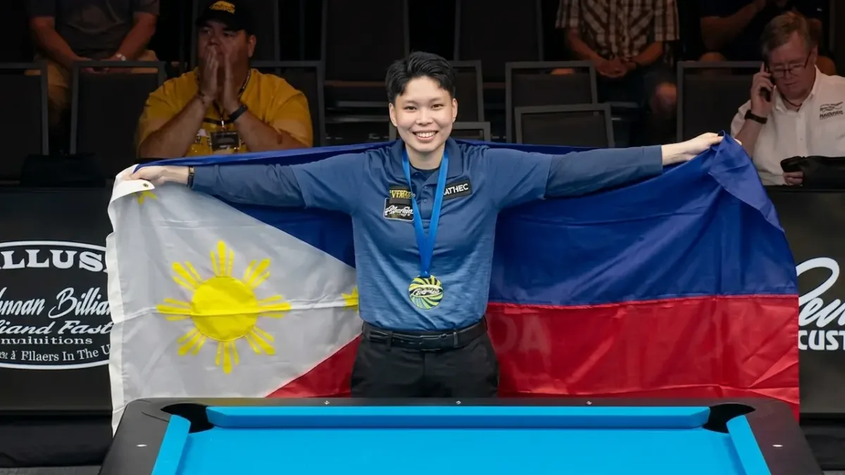 Chezka Centeno smiles proudly while holding open the Philippine flag following her championship match victory on Tuesday, Aug. 4, 2026. The Zamboanga City billiards star dedicated her world 8-ball victory to her late mother, Josephine, who passed away three months prior to the tournament. (Photo courtesy of WPA)