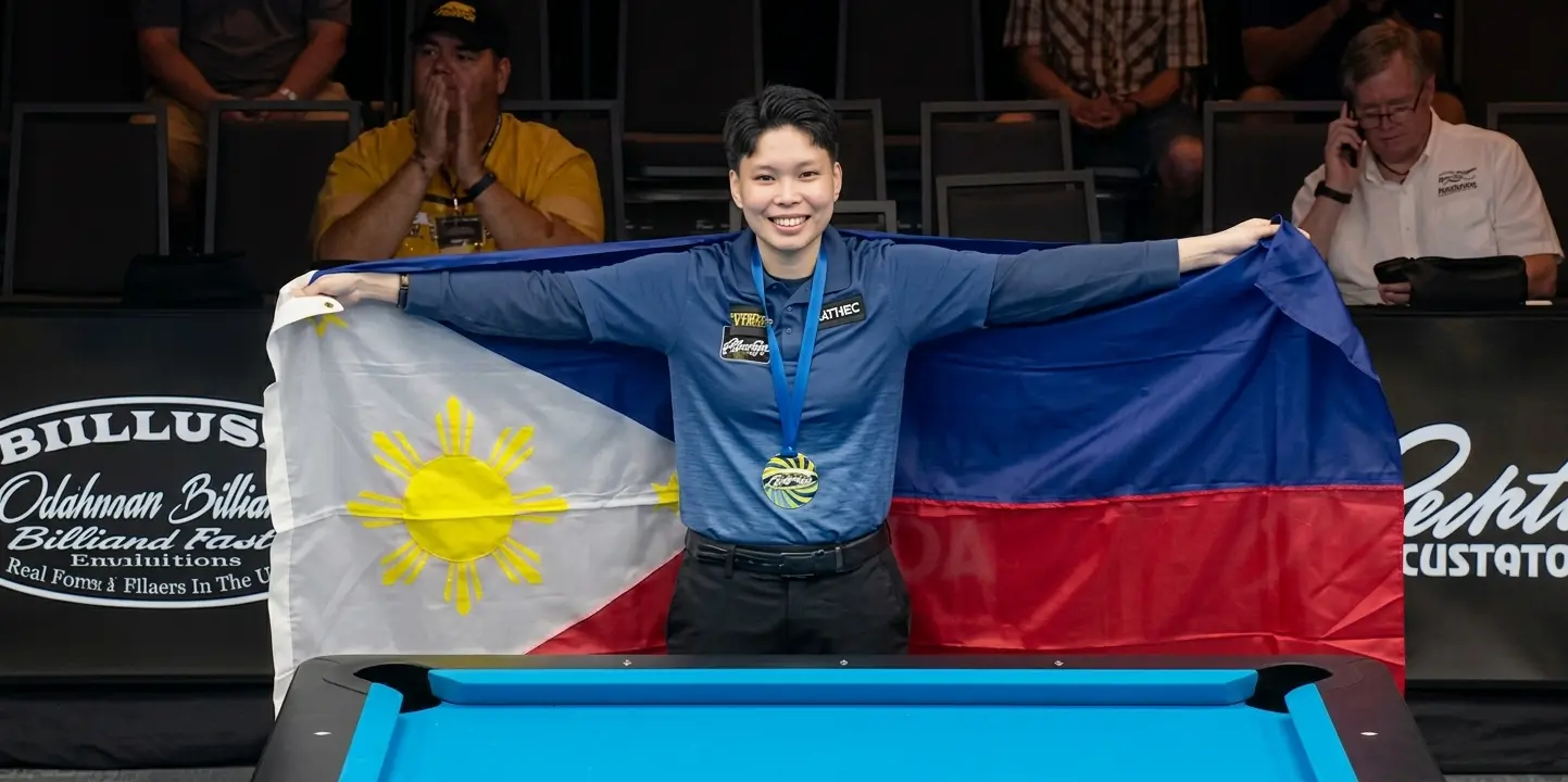 Chezka Centeno smiles proudly while holding open the Philippine flag following her championship match victory on Tuesday, Aug. 4, 2026. The Zamboanga City billiards star dedicated her world 8-ball victory to her late mother, Josephine, who passed away three months prior to the tournament. (Photo courtesy of WPA)