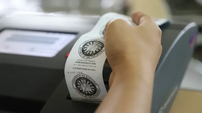 A poll technician verifies the printed output from a vote-counting machine during automated voting system testing. Election workers in Misamis Oriental are undergoing technical drills and equipment testing to ensure full operational readiness for precinct workers across local barangays ahead of the scheduled November polls. (Photo courtesy of DOST)