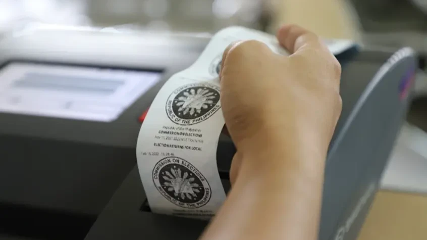 A poll technician verifies the printed output from a vote-counting machine during automated voting system testing. Election workers in Misamis Oriental are undergoing technical drills and equipment testing to ensure full operational readiness for precinct workers across local barangays ahead of the scheduled November polls. (Photo courtesy of DOST)