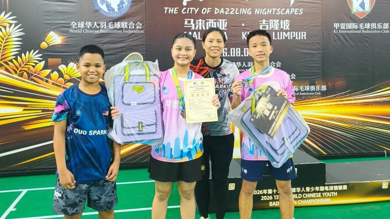 U17 Mixed Doubles silver medalists Raphaelle Dinara "Orange" Aguinea (center-left) and Hanz Yaw (right) display their certificates and awards alongside 11-year-old athlete Remiel Alessandri Aguinea (left) and Duo Sparks Coach Daphne Ng (center-right) in Kuala Lumpur, Malaysia. The 14-year-old Filipina shuttler from General Santos City paired with Malaysian teammate Yaw to reach the finals at the 13th World Chinese Youth Badminton Championship. (Photo courtesy of Duo Sparks)