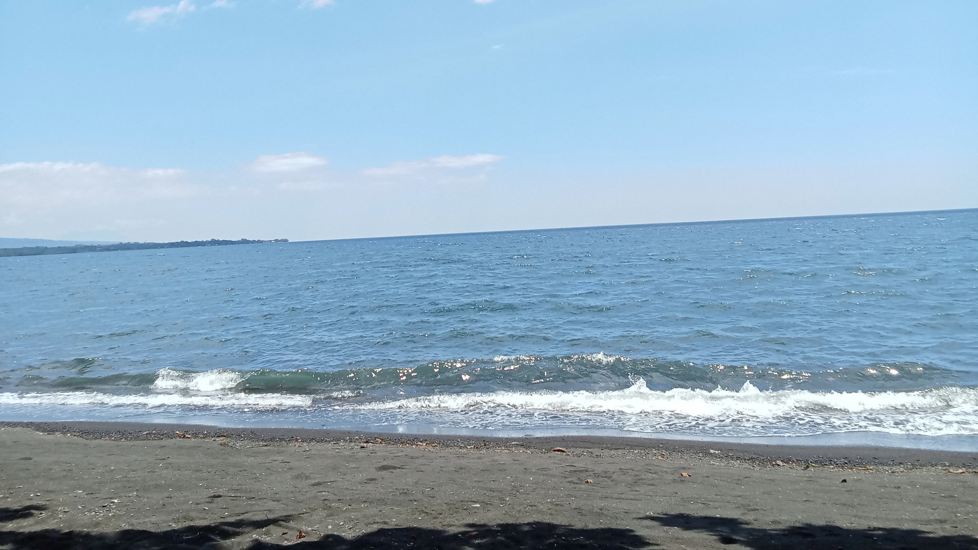 Waves lap along the coastal shoreline facing the Puntod Shoal marine sanctuary in Gingoog City. City Environment and Natural Resources Office (ENRO) Head Engr. John Keno T. Ong urged residents to strengthen waste management, warning that land-based garbage threatens offshore marine protected areas. (Photo by Edwin Iyo)