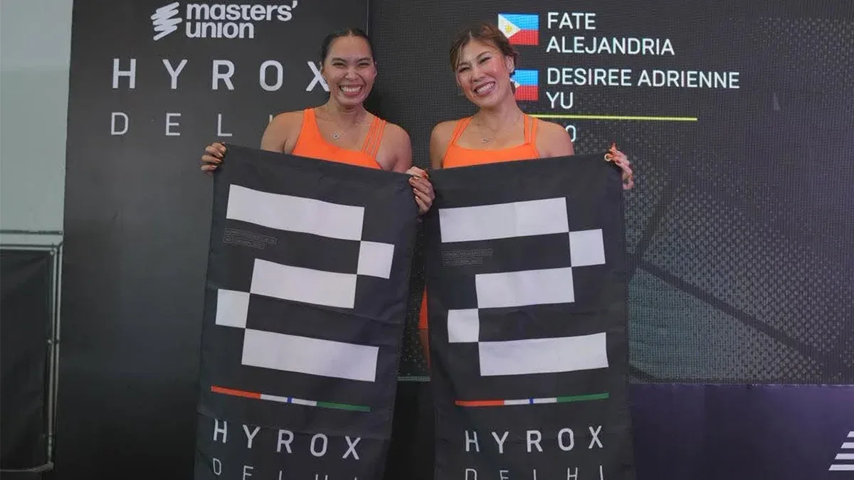 Desiree Adrienne Lim Yu (left) and Fate Alejandra hold HYROX Delhi banners in New Delhi, India, on July 26, 2026. The Mindanao-based duo secured second place in the Doubles division at the international fitness competition following eight months of joint preparation. (Photo courtesy of Desiree Adrienne Yu / Fate Alejandra)