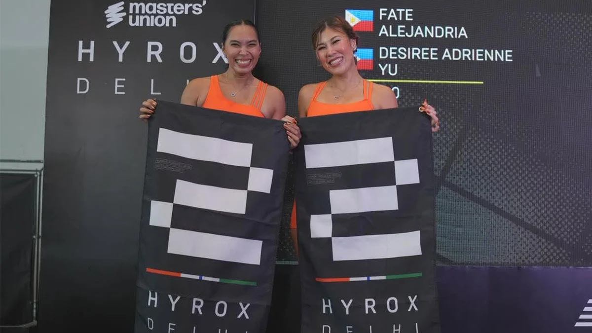 Desiree Adrienne Lim Yu (left) and Fate Alejandra hold HYROX Delhi banners in New Delhi, India, on July 26, 2026. The Mindanao-based duo secured second place in the Doubles division at the international fitness competition following eight months of joint preparation. (Photo courtesy of Desiree Adrienne Yu / Fate Alejandra)