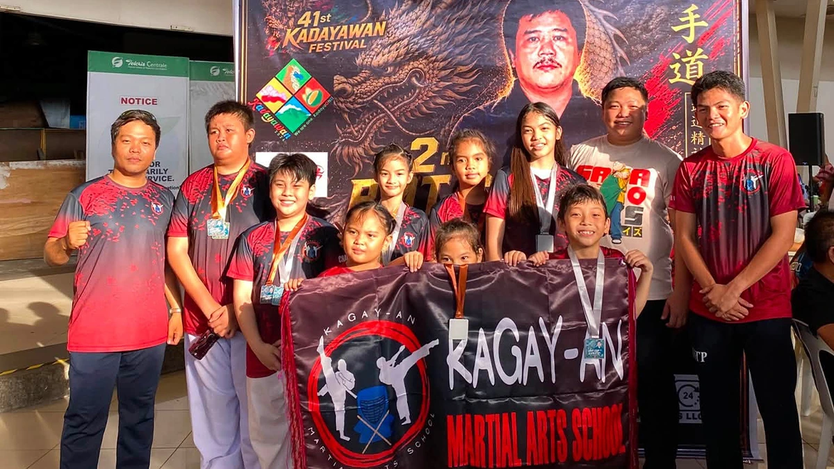 REGIONAL KARATE SUCCESS: Instructors and athletes from the Kagay-an Martial Arts School (KMAS) display their medals and team banner following their performance at the 2nd RMT Karate Tournament at Felcris Centrale in Davao City. The Cagayan de Oro-based squad captured 17 medals—four gold, seven silver, and six bronze—across various youth and senior Kata and Kumite divisions. (Photo courtesy of Kagay-an Martial Arts School (KMAS))