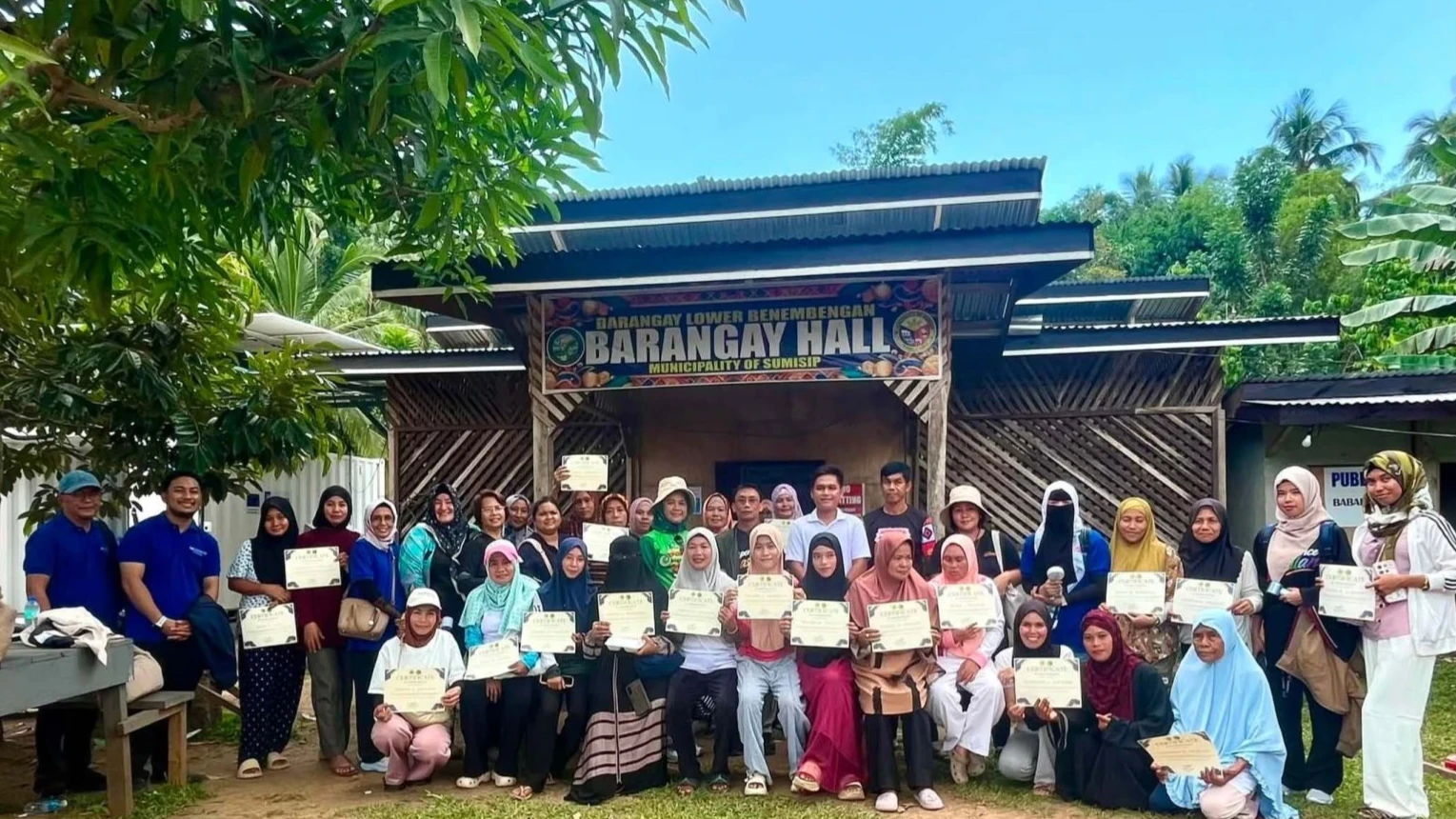Women MSME leaders and organizers display their certificates following the Business Expense Savings Training (B.E.S.T.) Game conducted by MTIT-Basilan in Brgy. Lower Binembengan, Sumisip, Basilan, aimed at bolstering local ice production enterprises.