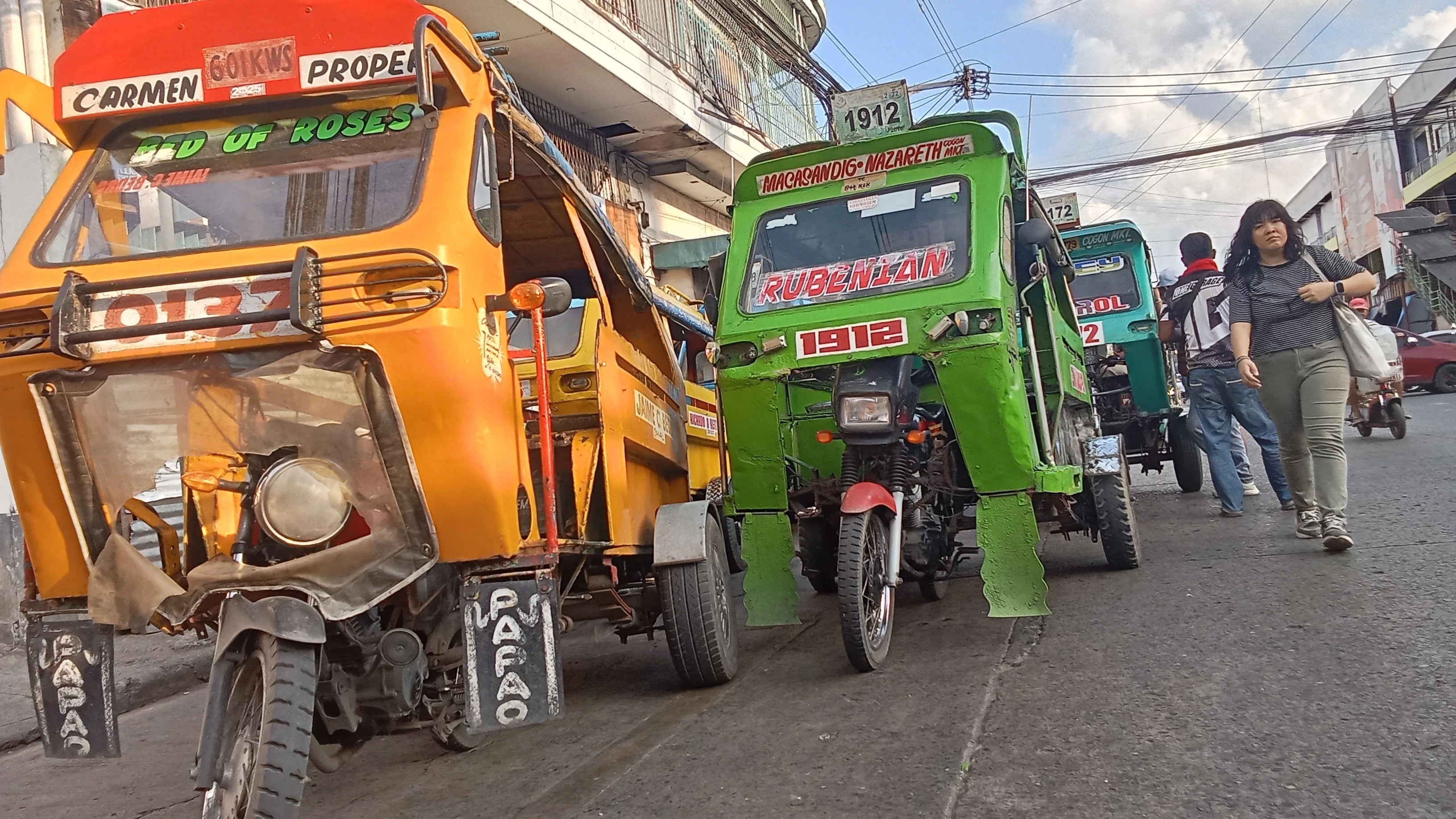 Motorelas, locally known as relas, line up to pick up commuters along Osmeña Street near Cogon Market in Cagayan de Oro City. The iconic  public utility vehicles remain a primary mode of short-distance public transportation across local commercial districts in this city. (Photo by Edwin Iyo)