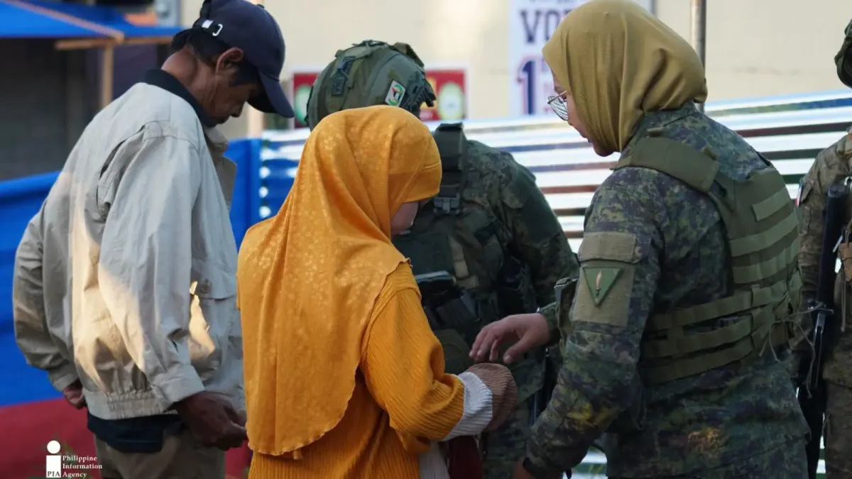 SECURITY CHECK. Security personnel check a voter before allowing entry to a polling center during the Bangsamoro parliamentary elections on Sept. 14 in Lanao del Sur. The inspection was part of security measures to keep voters and election workers safe. (Photo courtesy of JAKA/PIA-10/Lanao del Sur)