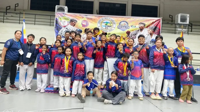Bushido thru Martial Arts Development Association athletes and head Sensei Michael Pabillore pose at the Malaybalay City Karatedo Championship in Bukidnon. BMDA gold medalists Ethan Jeade P. Leo, Gabrielle Q. Balquedra, Leirian Gabrielle Obsioma, Erle Matthew Redoble, Caleb Bacay, Jeiro Ortega, Kevin Calipayan, and Crischia Okit led the 36-medal tally in Northern Mindanao. Photo Courtesy of BMDA