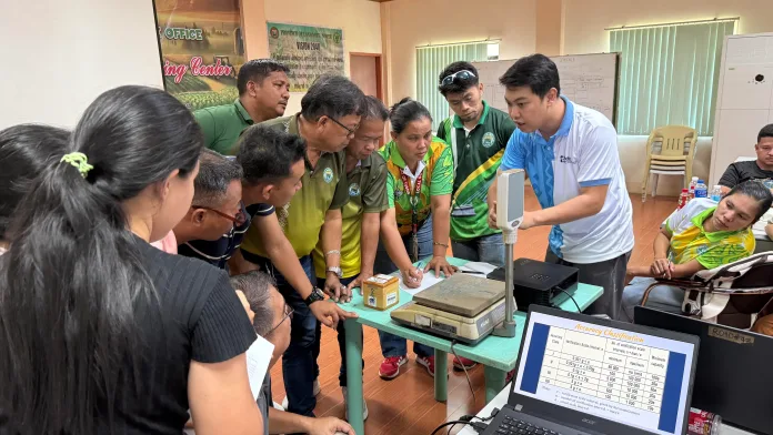 CHECKING FUEL PUMPS. DOST-NorMin metrology personnel and LGU trainees verify a fuel dispensing pump at a gasoline station in Lanao del Norte as part of the three-day training on accurate measurements.