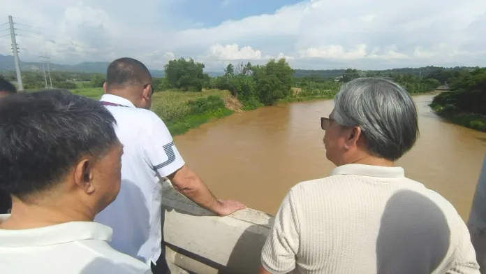 DREDGING PLAN. DPWH Undersecretary Charles Calima (center) inspects the Tagoloan River in Misamis Oriental as the agency explores possible assistance from private quarry companies for dredging works to address its shallow and silted portions. With him are local officials and stakeholders working to fast-track the completion of the Tagoloan Bridge. Photo by Shiela Mae Butlig