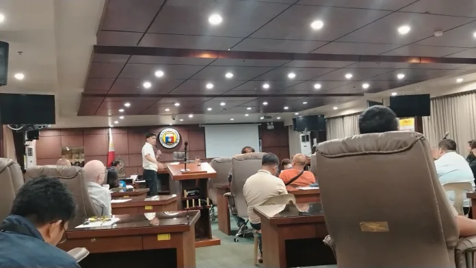 Opol Mayor Jay Francis Bago addresses the Cagayan de Oro City Council at the podium during a committee session on September 23 regarding provincial PUV route restrictions.