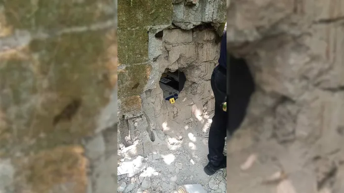 ENTRY POINT. Police inspect the opening allegedly created by the suspects on the rear concrete wall of a commercial establishment in Ozamiz City, Misamis Occidental, through which they reportedly gained entry before forcibly opening the vault and taking an estimated P60,000 in cash. Police later linked the suspects to the alleged Pondoyo Robbery Group. (Photo courtesy of PRO-10)