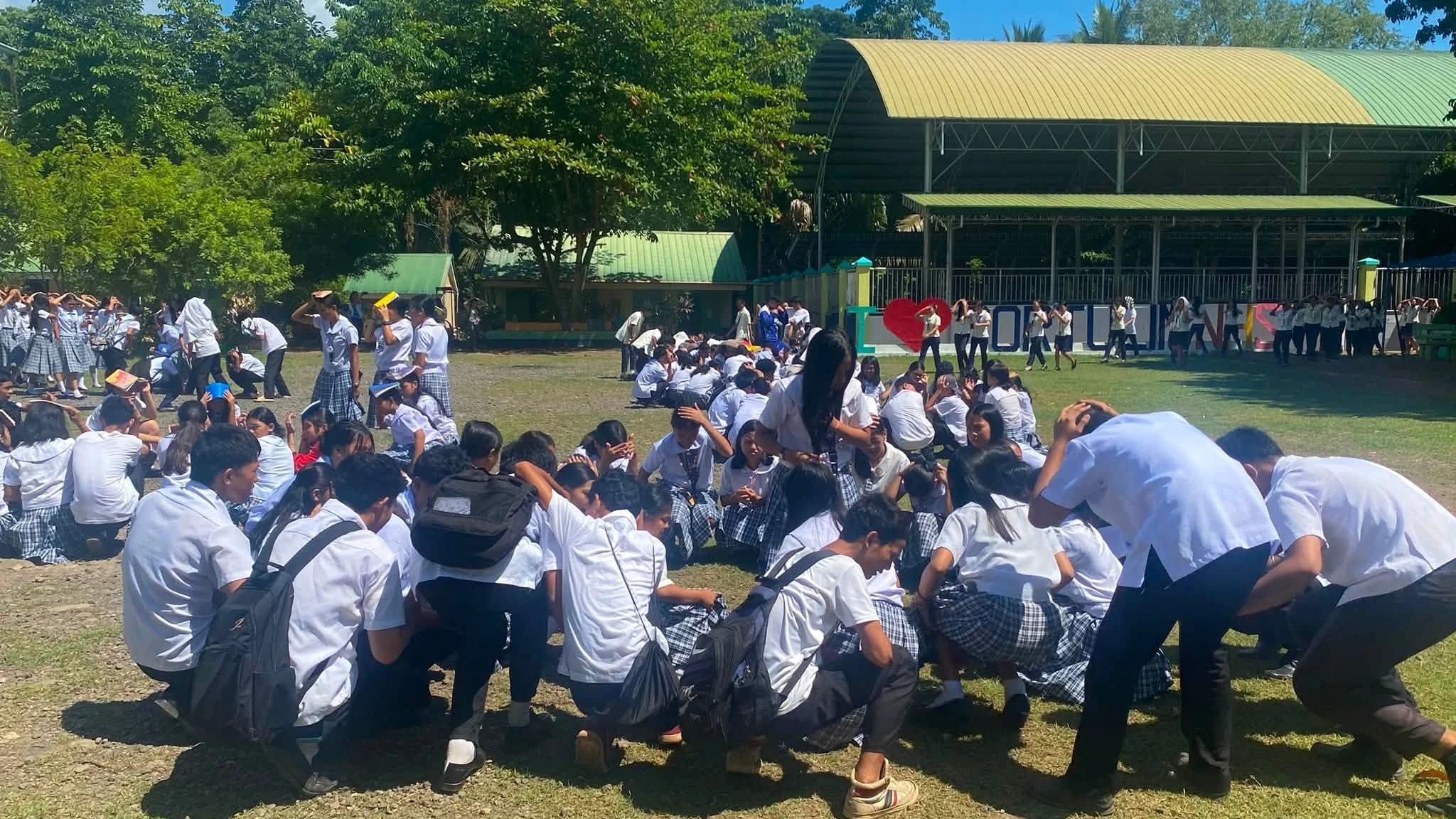 SAFETY FIRST. Learners and school personnel of Portulin National High School take part in a school safety drill in Medina, Misamis Oriental, early August this year. File photo courtesy of Portulin National High School