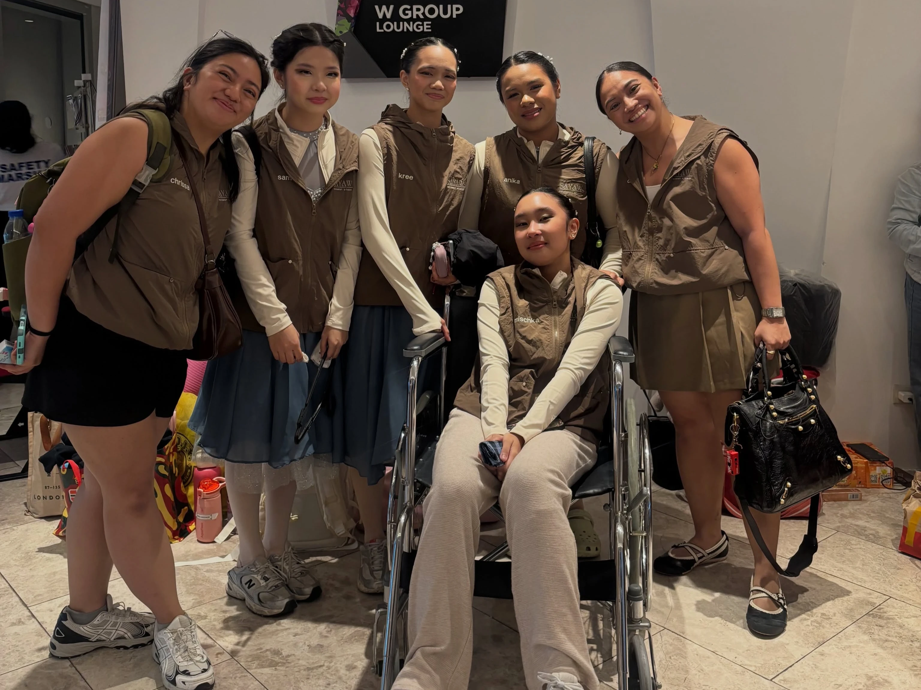 Sayaw Movement Studio dancers and instructors support an injured team member at the BGC Arts Center during the national MNL Dance Prix in Taguig City. Despite the injury setback requiring a emergency choreographic adjustment, the Cagayan de Oro dance troupe took home top honors in the ballet ensemble category. (Photo courtesy of Sayaw Movement Studio)
