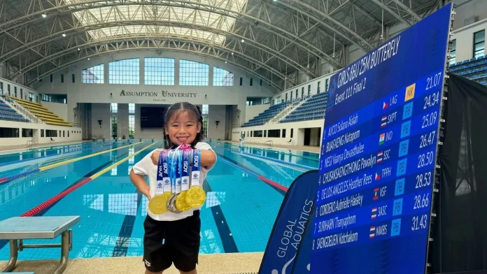 Young Philippine swimmer Solana Aislah “Daday” Ayco poses with her gold and silver medals at Assumption University in Bangkok, Thailand. The Valencia City, Bukidnon native set a tournament record of 21.07 seconds in the 25-meter butterfly during the 3rd Asian Open Schools Invitational Short Course Swimming Championships.