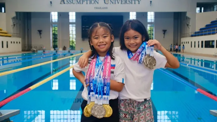 Young Filipino athletes Solana Aislah Ayco (left) and Julia Lois Palo (right) celebrate winning eight total medals at the 3rd Asian Open Schools Invitational Short Course Swimming Championships in Bangkok, Thailand. The young swimmers represented Valencia City and Malaybalay City, Bukidnon, on the international stage. (Photo courtesy of Ayco and Palo Families)