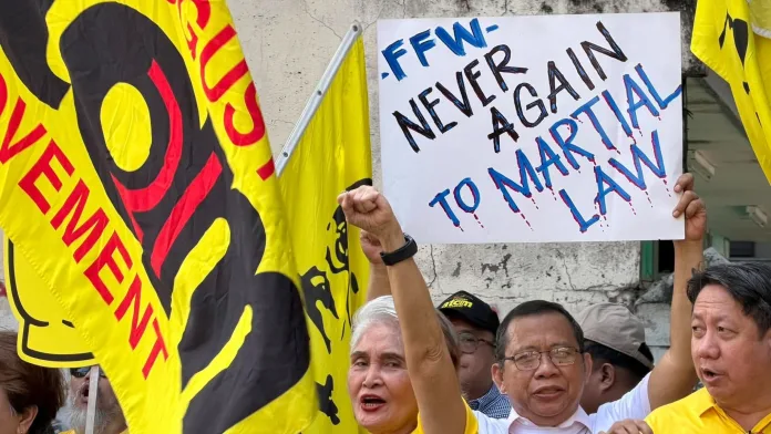 DEMOCRACY BEYOND THE BALLOT BOX — Federation of Free Workers (FFW) President Atty. Sonny Matula and members hold a “NEVER AGAIN TO MARTIAL LAW” placard during a Martial Law anniversary observance, calling for stronger unions, collective bargaining, job security and living wages. (Photo supplied)