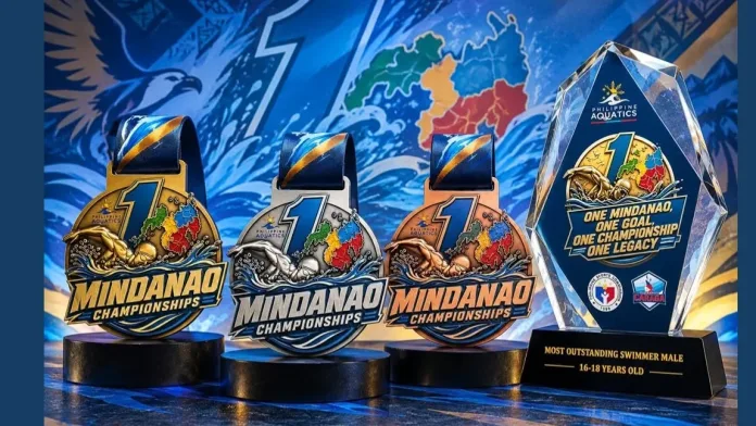 The official gold, silver, and bronze finisher medals alongside a crystal championship trophy for the 1st Mindanao Swimming Championships 2026, set against a backdrop featuring the Philippine Aquatics and Philippine Sports Commission logos and a map of Mindanao.