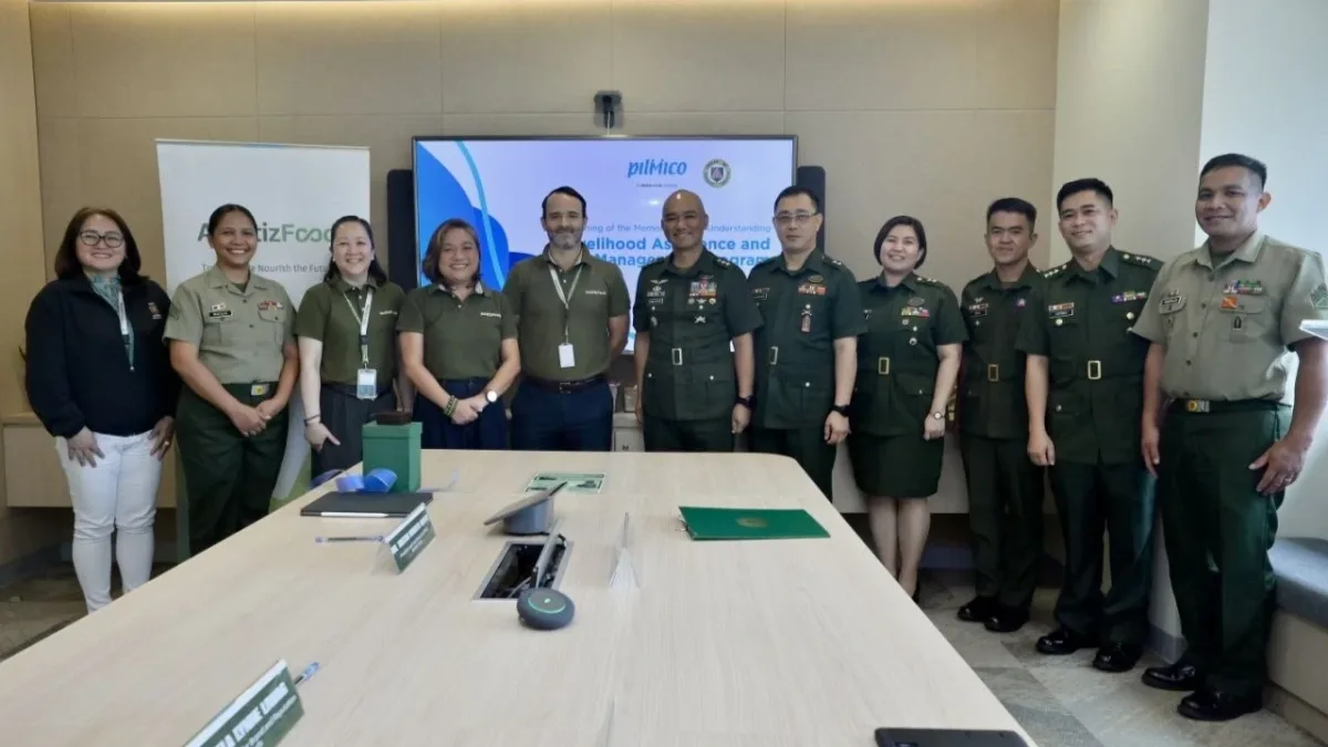 Aboitiz Foods President and CEO Tristan R. Aboitiz and Philippine Army Personnel Management Center Director Col. John Mark S. Competente standing together holding a formal agreement for the Livelihood Assistance and Management Program (LAMP).