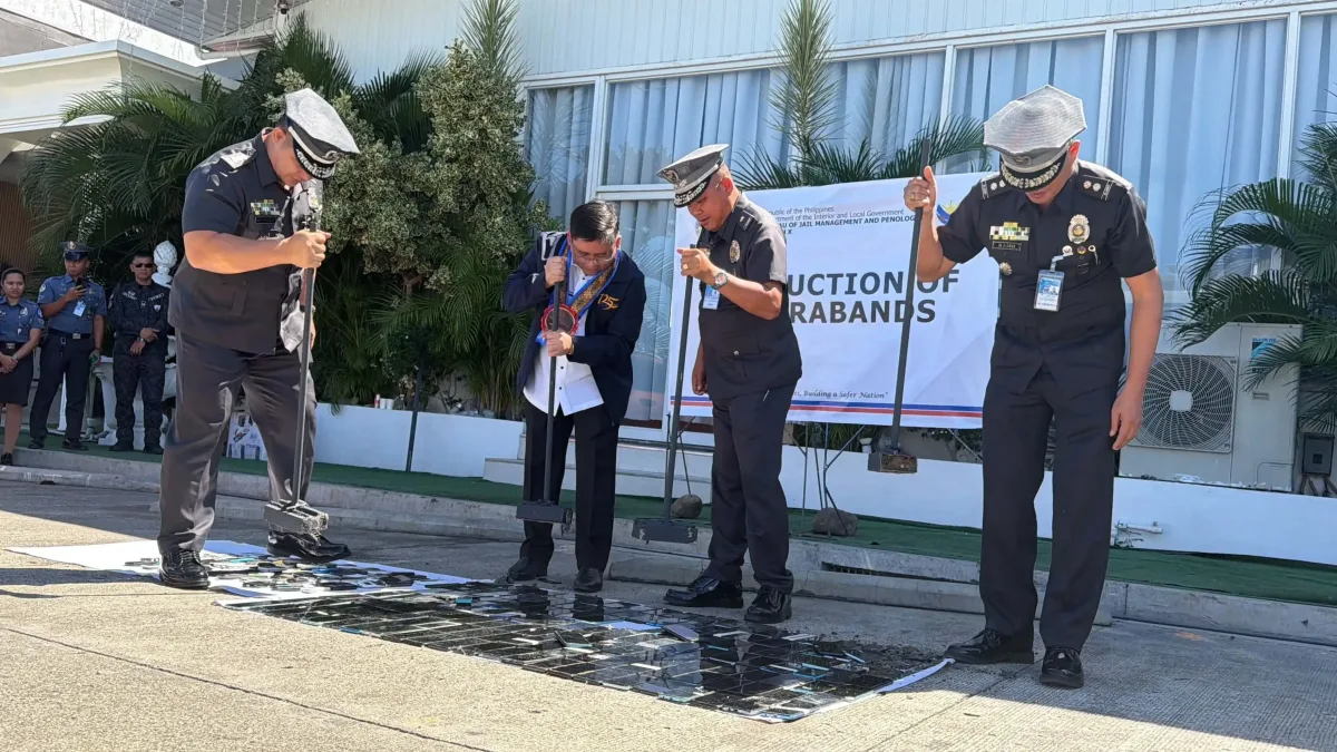 BJMP-10 Regional Director Jail Chief Superintendent Felixberto S. Jagorin Jr. and jail officers smash over 200 confiscated mobile phones with sledgehammers during a contraband destruction ceremony in Cagayan de Oro City.